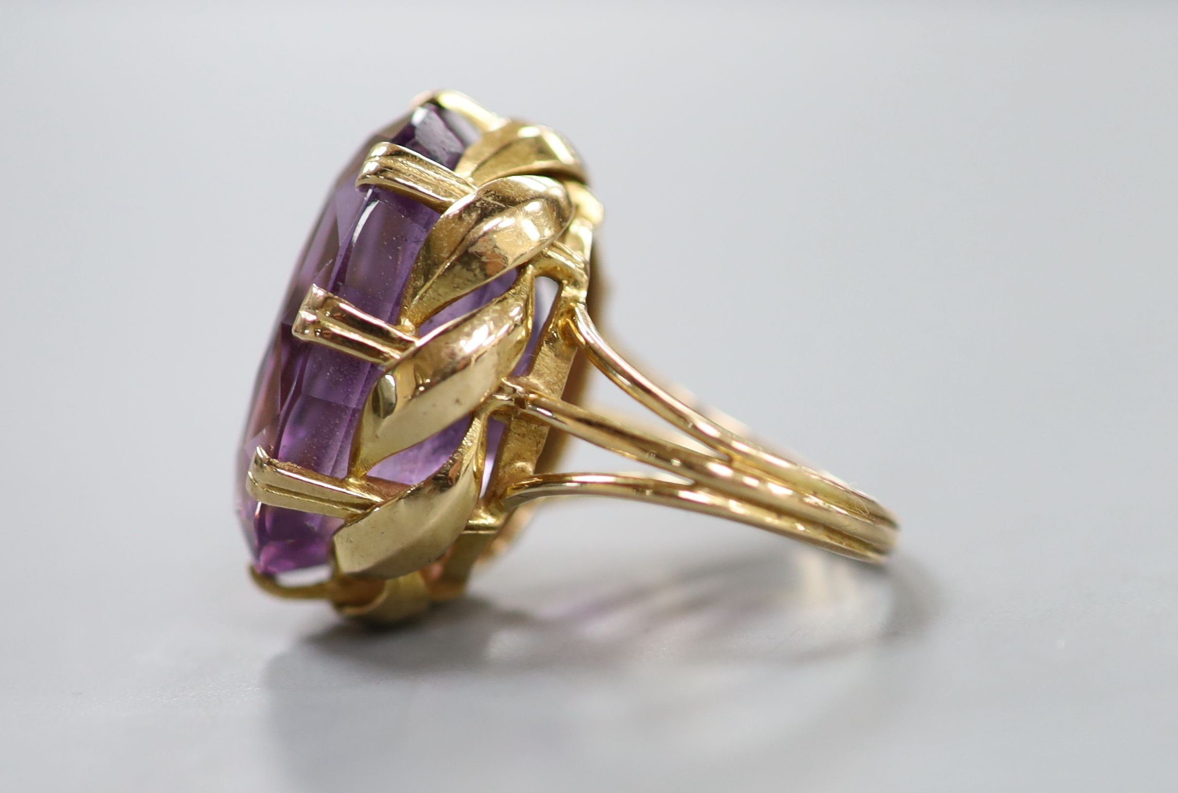 A yellow metal and oval cut amethyst set dress ring, size L, gross weight 11.5 grams.